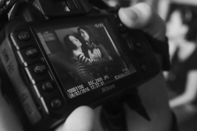 About 2 Monochrome image of a DSLR screen displaying a portrait, emphasizing photography.